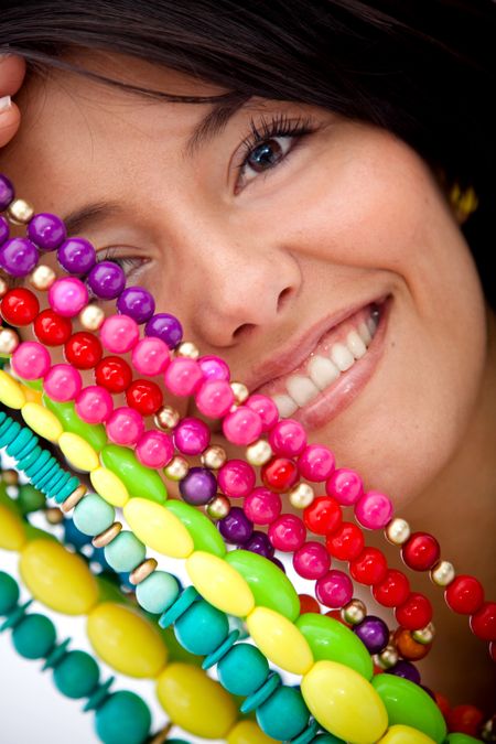 Girl with colorful jewelry isolated over a white background