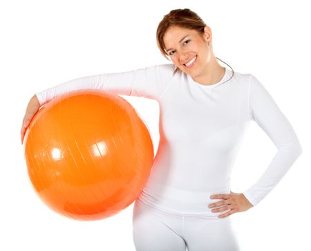 Woman with a pilates ball isolated over a white background