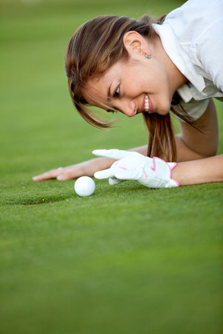 Beautiful golf female player flicking the ball outdoors