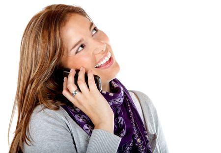 Woman talking on the phone smiling - isolated over a white background