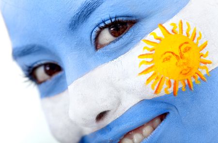 Portrait of a woman with the argentinean flag paited on her face - over a white background