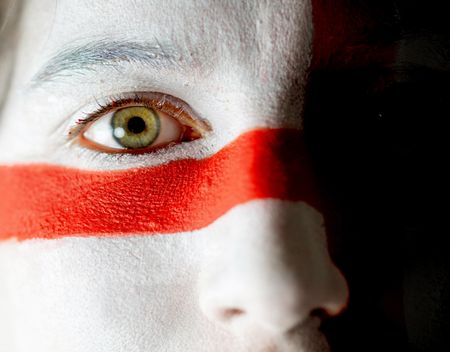 Portrait of a woman with the english flag paited on her face