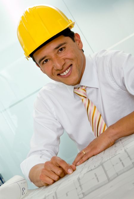 Male architect at the office wearing a helmet