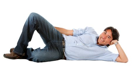 casual man smiling and lying on the floor isolated over a white background