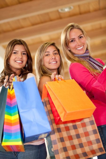 Group of women shopping in a mall with some bags