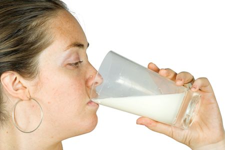 healthy woman drinking a glass of milk