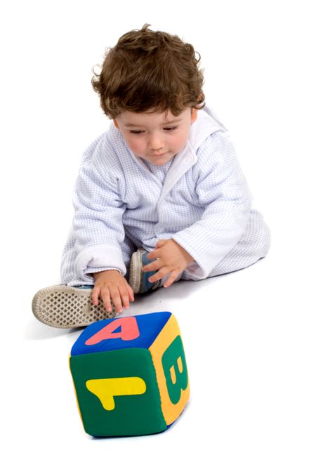 early learning boy on the floor with a teaching cube