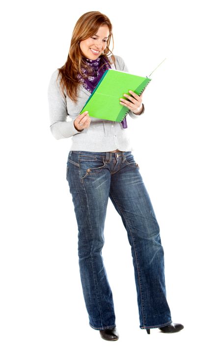 Beautiful female student reading a notebook isolated over a white background