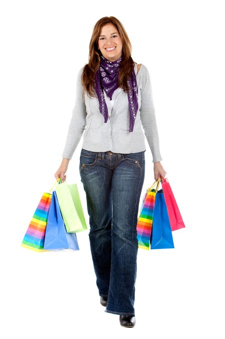 Shopping woman walking with bags isolated over a white background