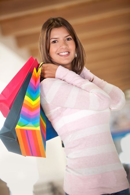 Beautiful shopping woman holding bags and smiling