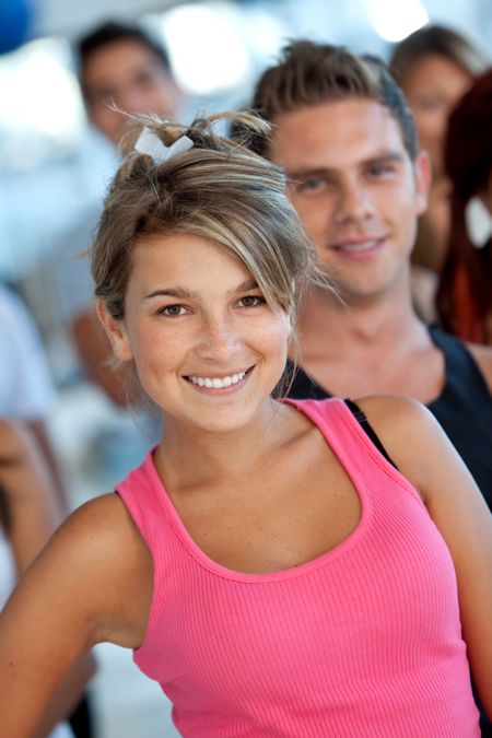 Beautiful young woman at the gym smiling