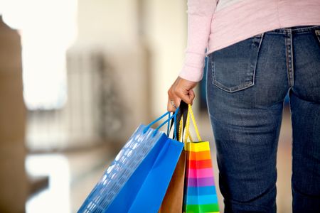 Rear view of a woman with shopping bags in a mall