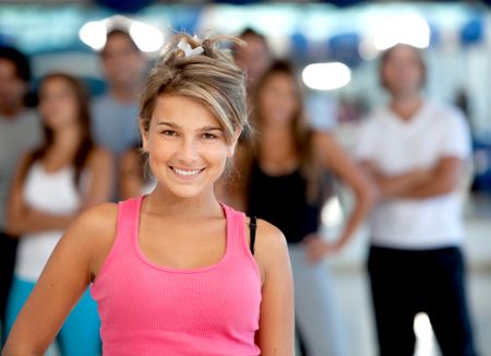 beautiful woman at the gym smiling in sportswear