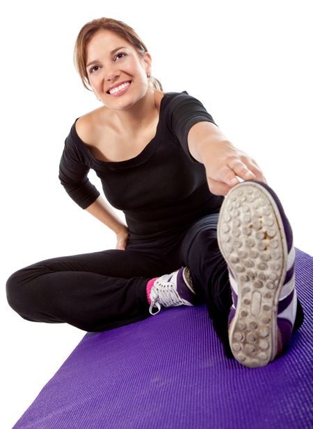 woman doing stretching exercises on the floor isolated over a white background