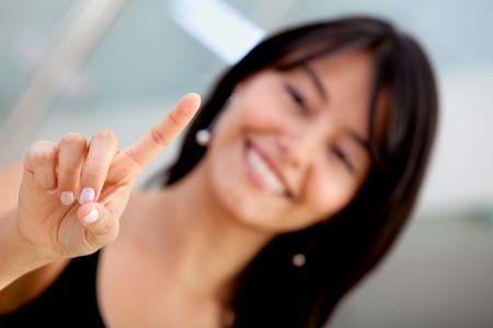 Business woman pressing an imaginary button and smiling