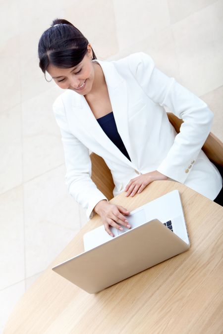 Business woman working on the computer at the office