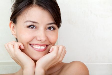 Beauty portrait of a female smiling at a bathroom