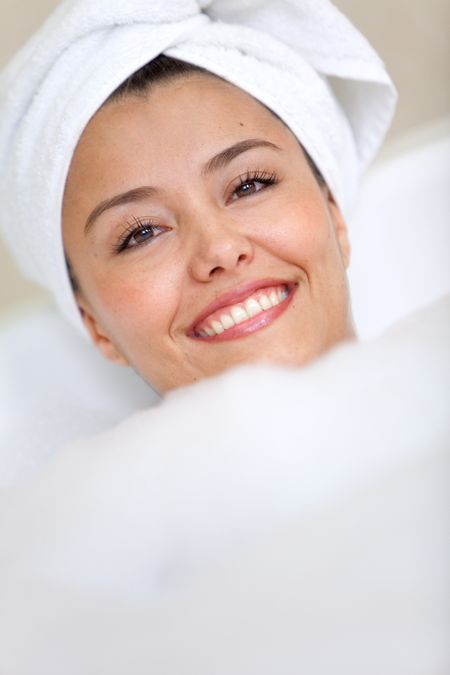 woman taking a bath with a towel on her head - Beauty concepts
