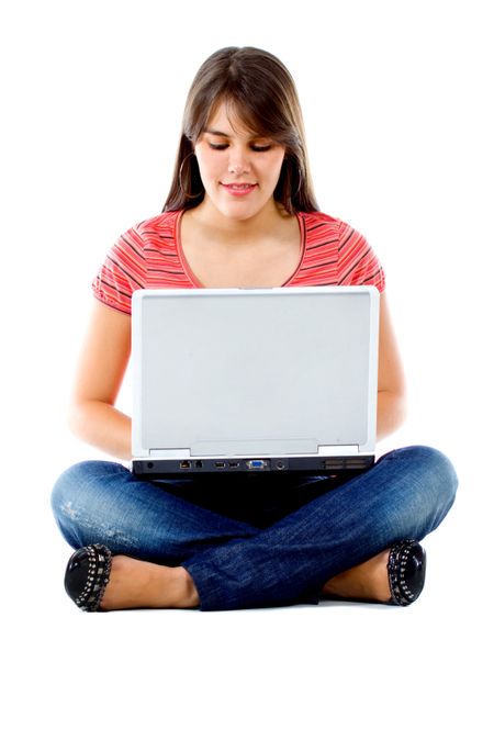 Girl sitting with a laptop isolated over a white background