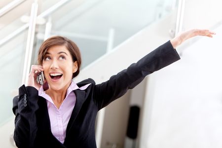 Business woman full of joy on the phone