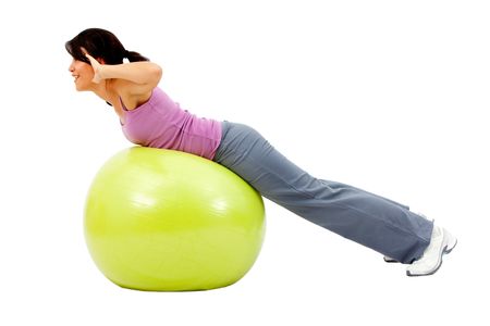 beautiful woman portrait exercising on a pilates ball - Isolated over a white background
