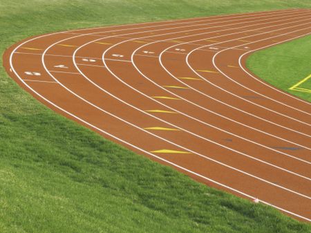 Tilted view of curve in eight-lane track for collegiate runners
