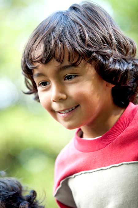 Portrait of a happy young boy smiling outdoors