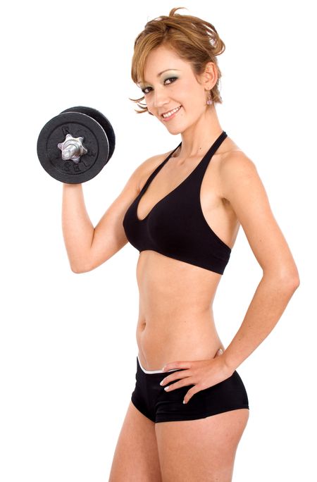 beautiful girl doing free weights while smiling over a white background
