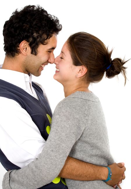 young couple smiling and having fun with faces against each other - isolated over a white background