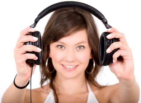 music for your ears - girl holding headphones in front of the camera over a white background