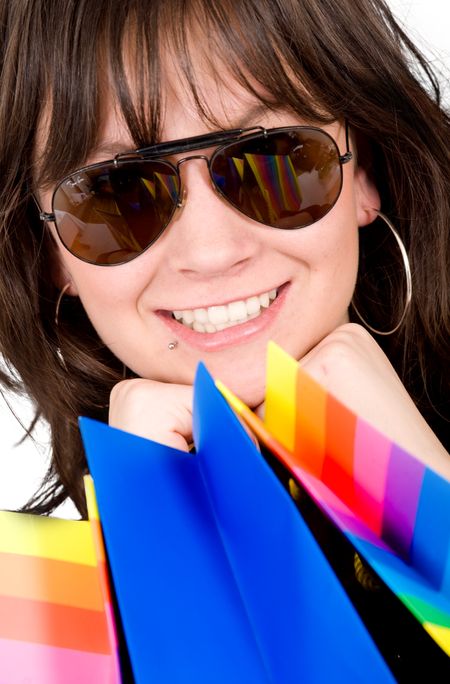 happy girl smiling and wearing sunglasses with shopping bags