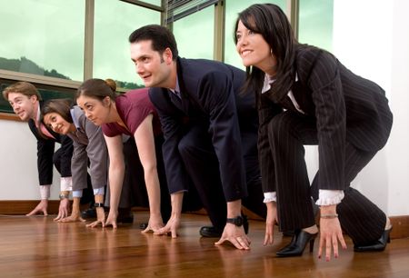 business team in a competition in the office - focus is on the face of the second guy from right to left