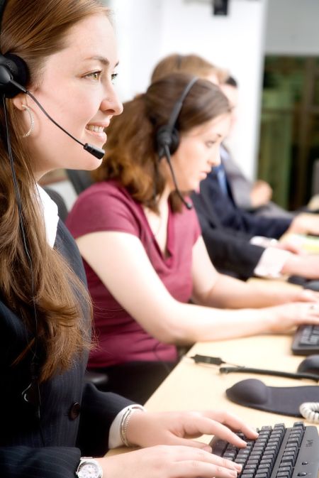 customer service representatives team in an office working on their computers