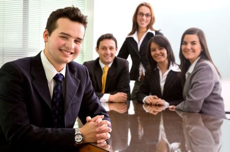 Business team in an office with a man leading