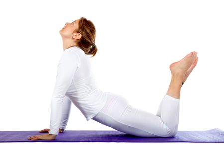 Woman practicing yoga over a mat - isolated on a white background
