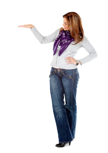 Fullbody casual woman displaying something imaginary isolated over a white background