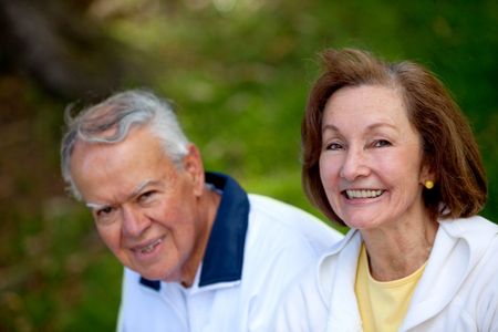 Portrait of a happy retired couple laughing outdoors