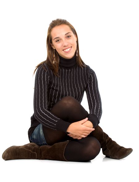 Casual woman portrait seating on the floor over a white background