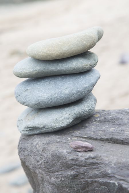 Stack of Four Stones on Beach