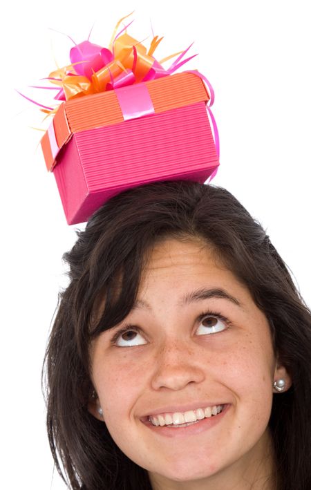 girl with gift on top of her head over a white background