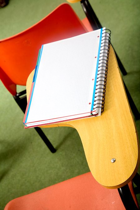 notebook on a desk in a classroom