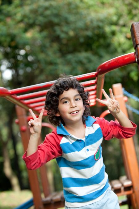 Sweet little boy playing at the park and smiling