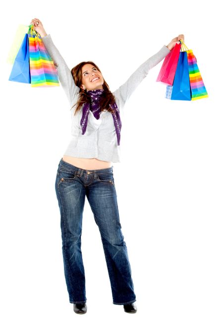 Happy shopping woman with bags isolated over a white background