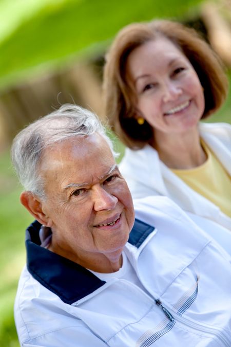 Happy retired couple outdoors smiling and enjoying nature