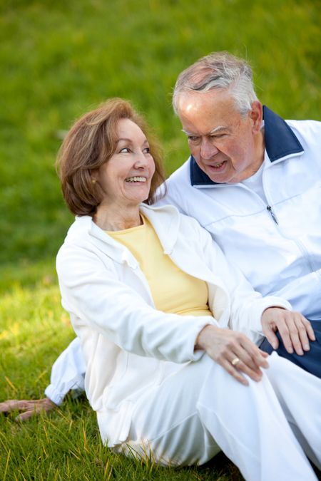 Happy retired couple outdoors smiling and enjoying nature