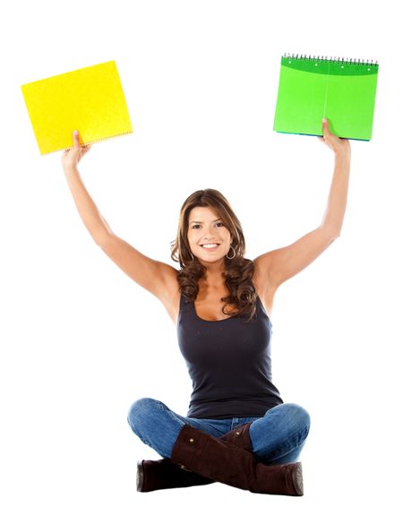 Happy female student holding notebooks isolated over a white background