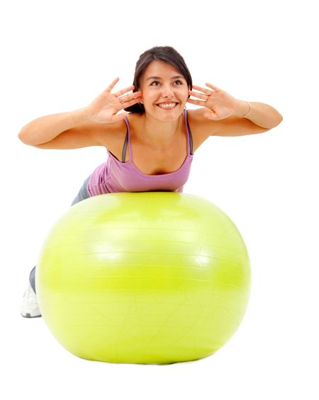 Woman exercising with a pilates ball isolated over a white background