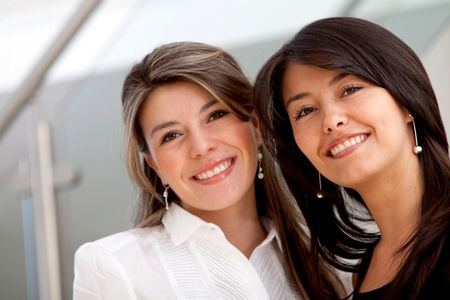 Young business women smiling at the office