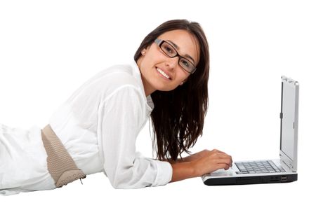 Woman wearing glasses and working on a laptop - isolated over white