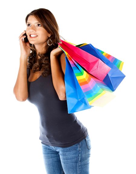 Shopping woman talking on the phone isolated over a white background